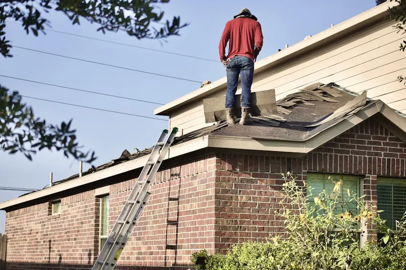 Professional roofer working on a residential roof in Blanch